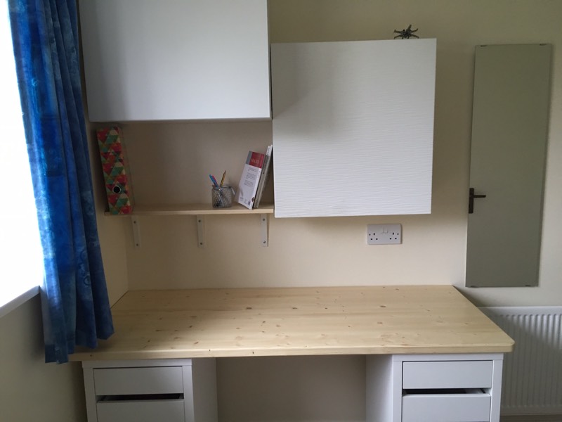 white and pine desk and wall cupboards